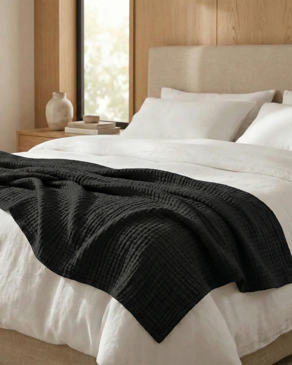Muslin Blanket in Black in a bedroom