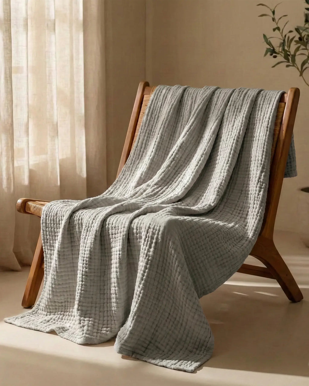 Muslin Blanket in Grey in a bedroom