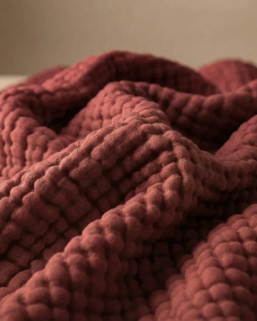 Muslin Blanket in Wine Red in a bedroom