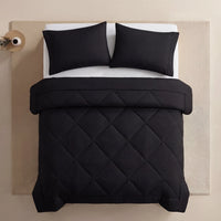 Nidora duvet in Midnight Black on a made bed